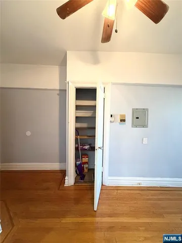 a view of a room with wooden floor