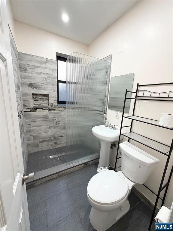 3718 Park Avenue, Unit D4 Weehawken, NJ 07086 - Photo 6 of 25 a bathroom with a toilet sink and shower