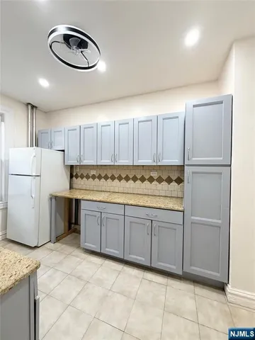 a kitchen with a refrigerator a stove a microwave and cabinets