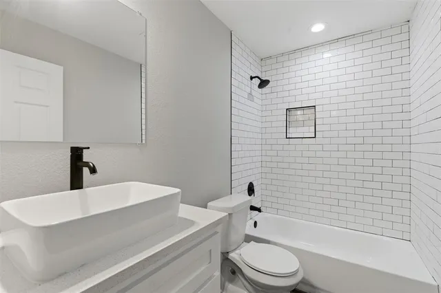 a bathroom with a sink a toilet and a bathtub