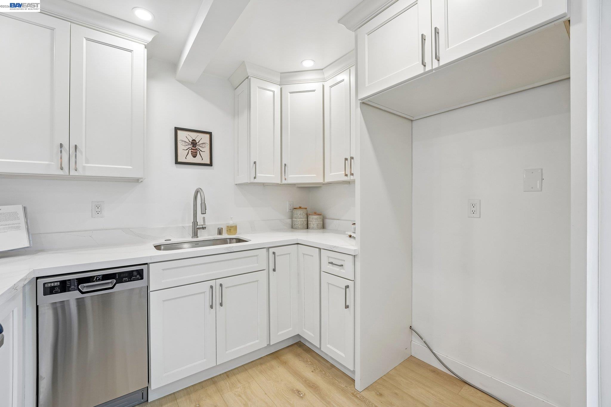 606 West 9th Street Santa Rosa, CA 95401 - Photo 30 of 52 a kitchen with white cabinets and sink
