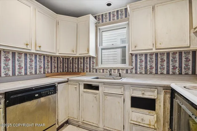 a kitchen with a sink stove and cabinets