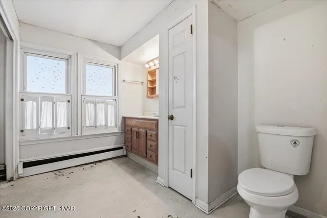 a bathroom with a tub a sink and a window