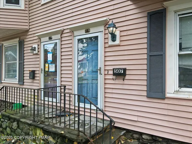 a view of a house with a door and wooden floor