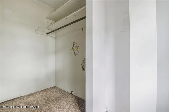 a view of a hallway with wooden floor and entryway