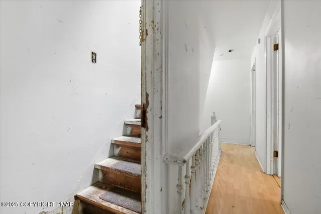 a view of an empty room with stairs