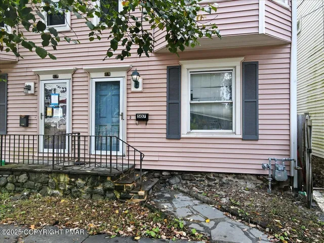 a view of a house with a yard and wooden floor