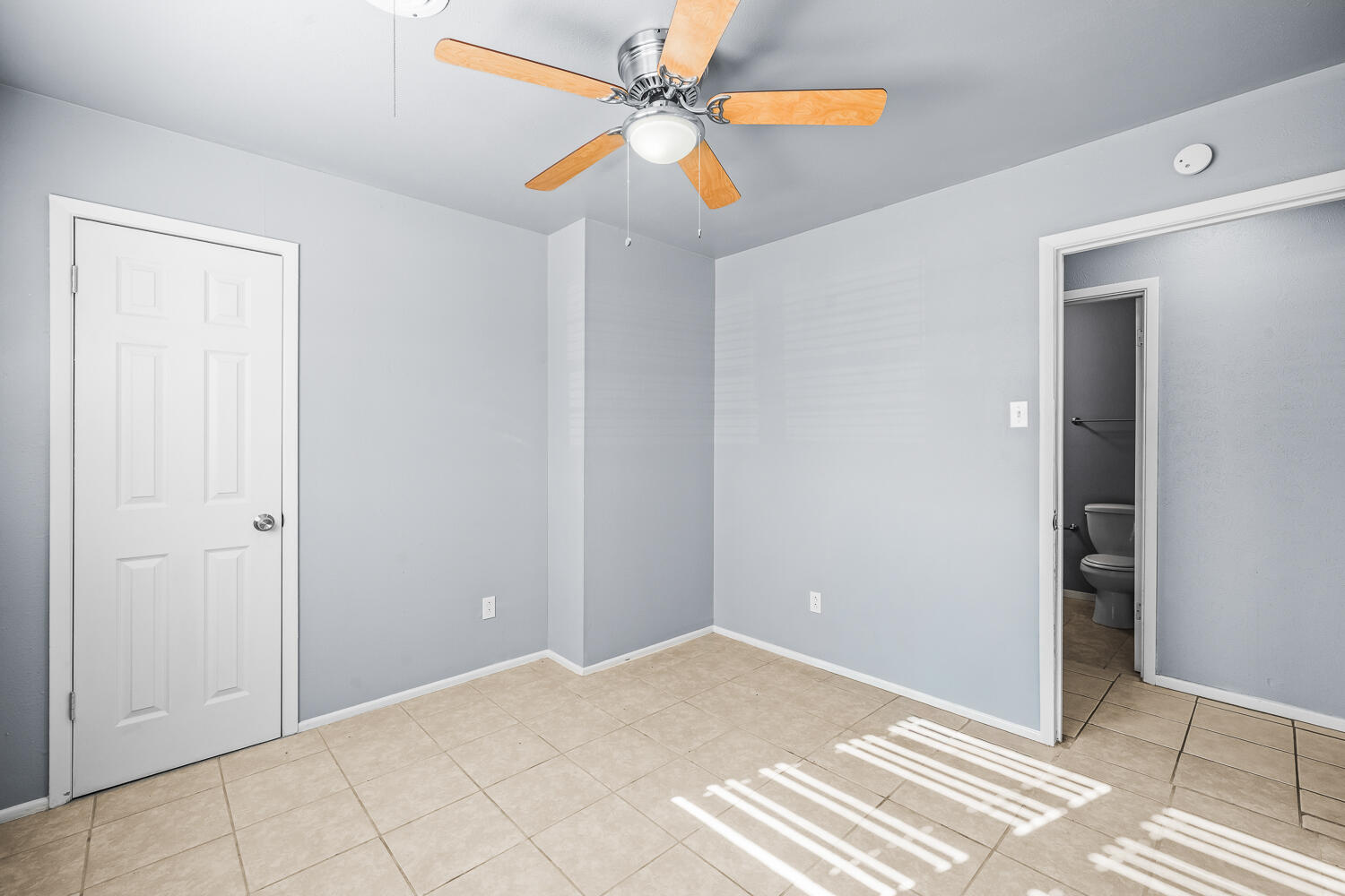 5522 17th Street Lubbock, TX 79416 - Photo 17 of 22 a view of a bedroom with wooden floor and a ceiling fan