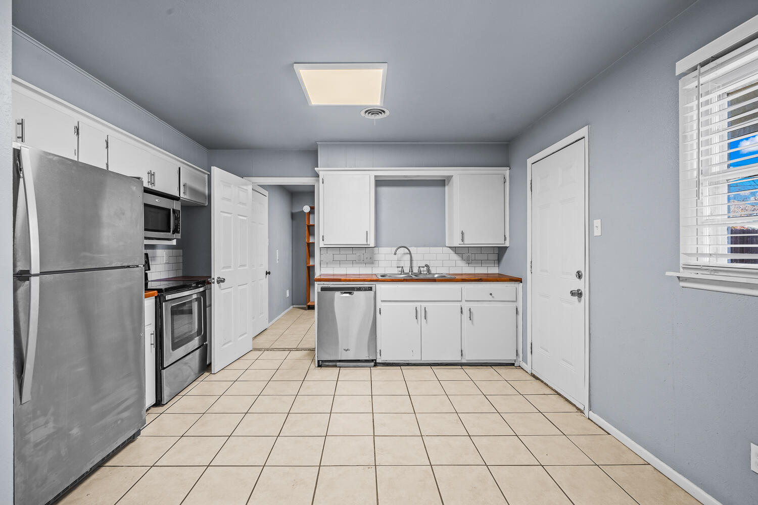 5522 17th Street Lubbock, TX 79416 - Photo 8 of 22 a kitchen with a refrigerator sink and cabinets