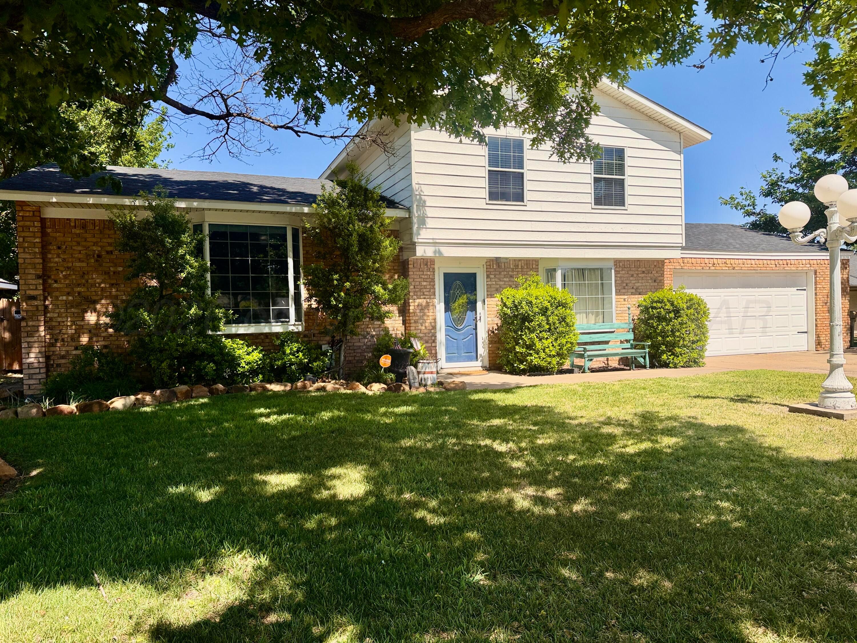 219 Inverness Street Borger, TX 79007 - Photo 1 of 35 a front view of a house with garden