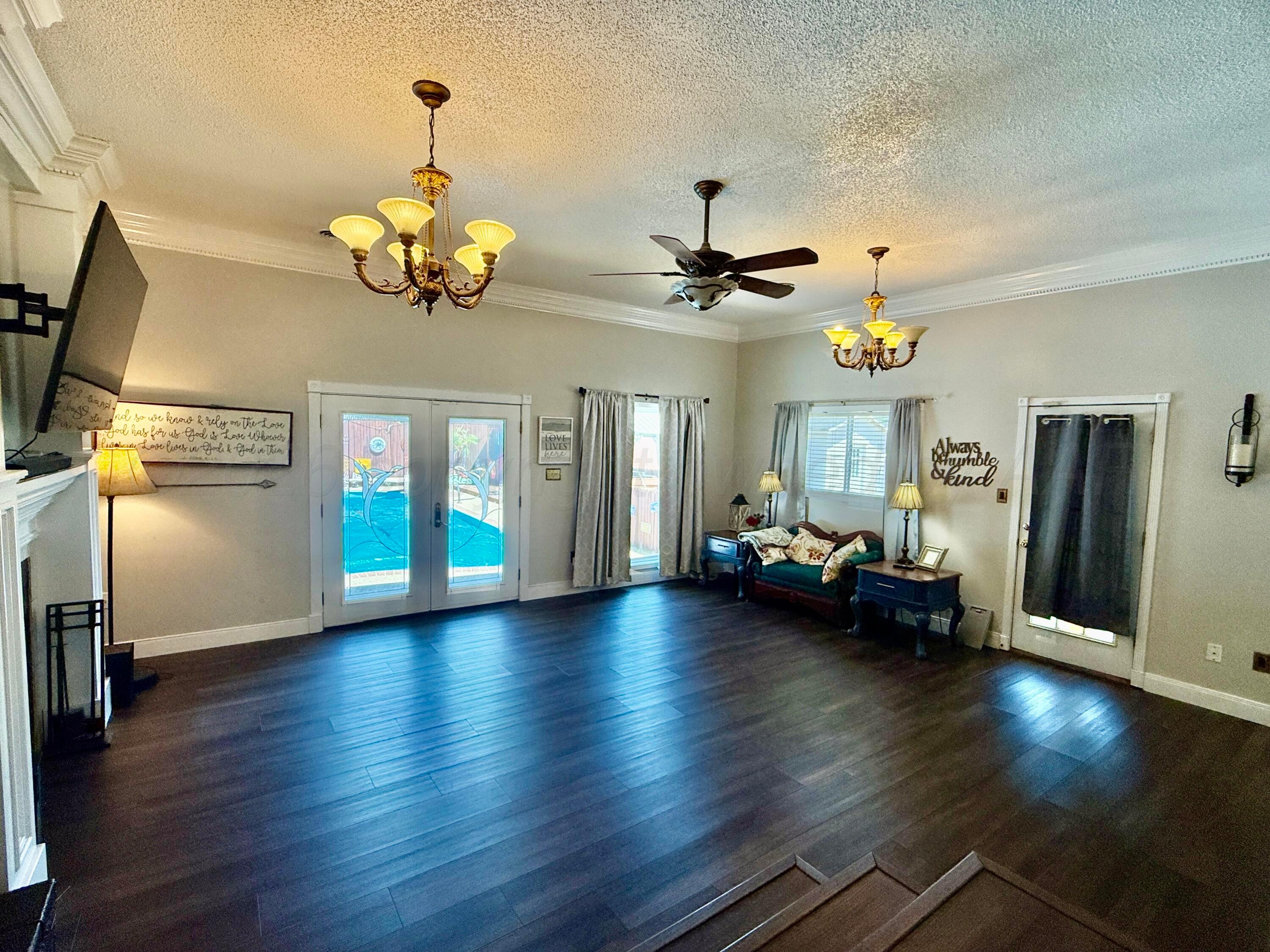 219 Inverness Street Borger, TX 79007 - Photo 13 of 35 a view of a livingroom with furniture wooden floor and chandelier