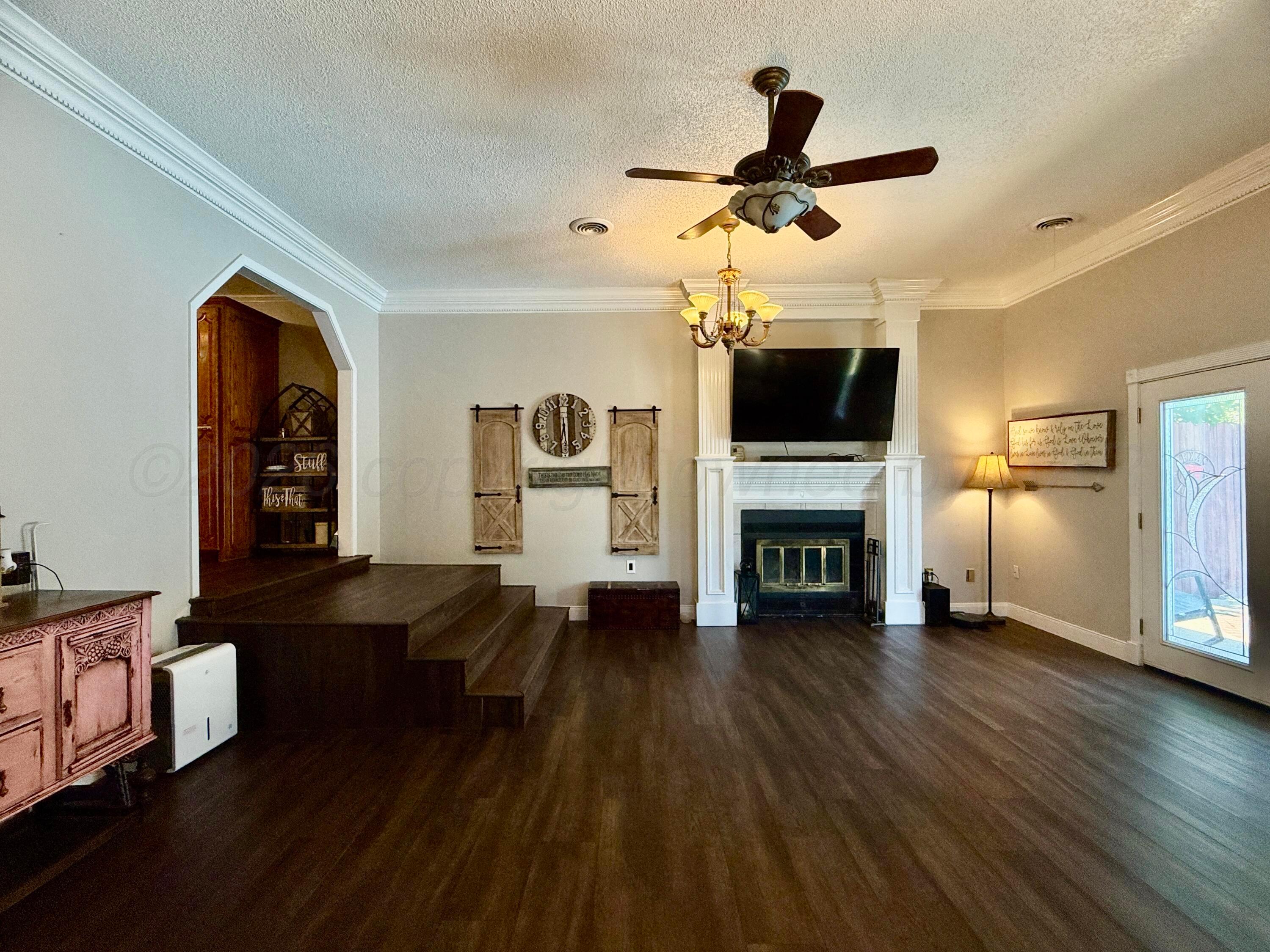 219 Inverness Street Borger, TX 79007 - Photo 15 of 35 a living room with fireplace furniture and a wooden floor