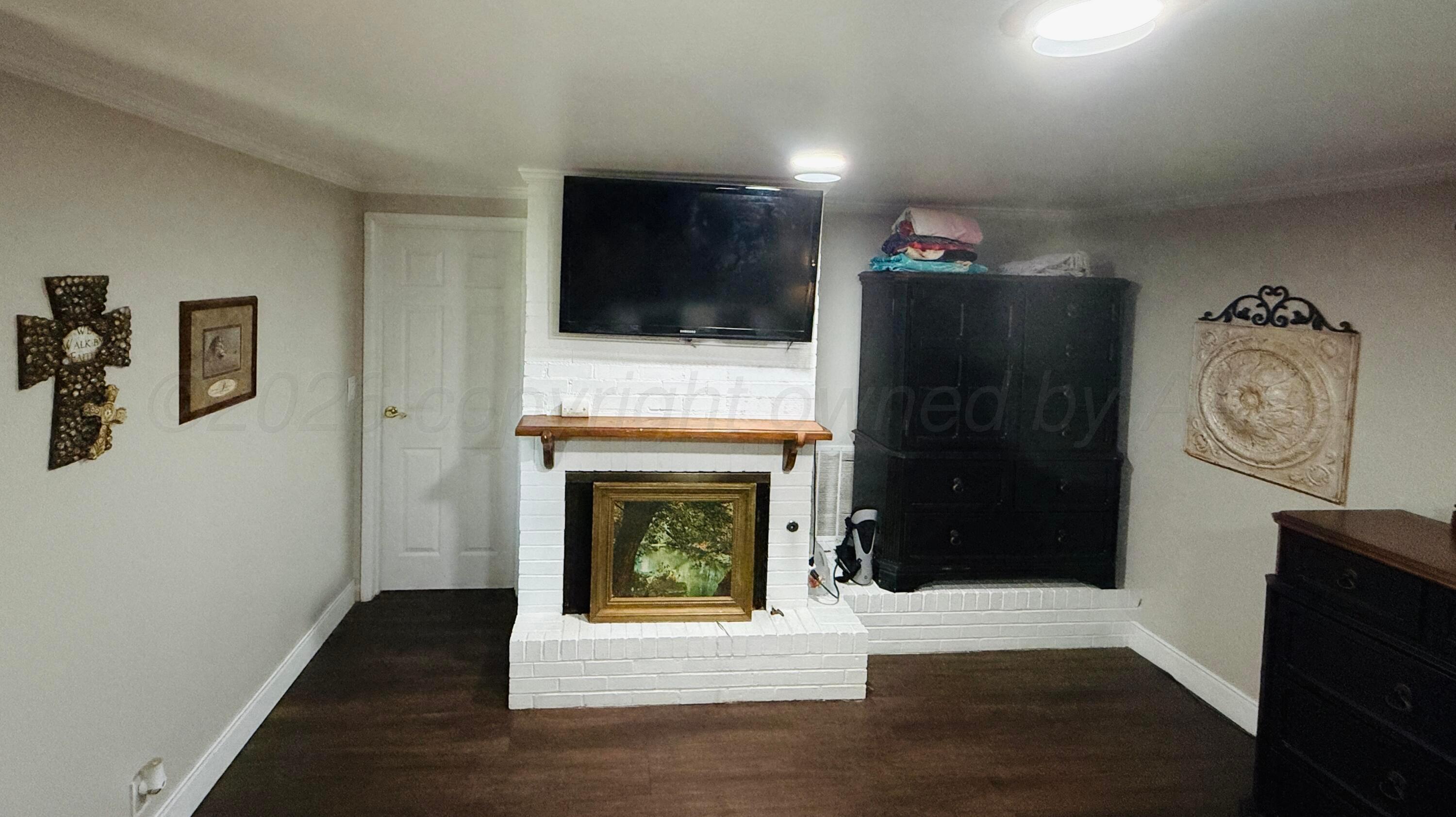 219 Inverness Street Borger, TX 79007 - Photo 18 of 35 a living room with furniture and a fireplace
