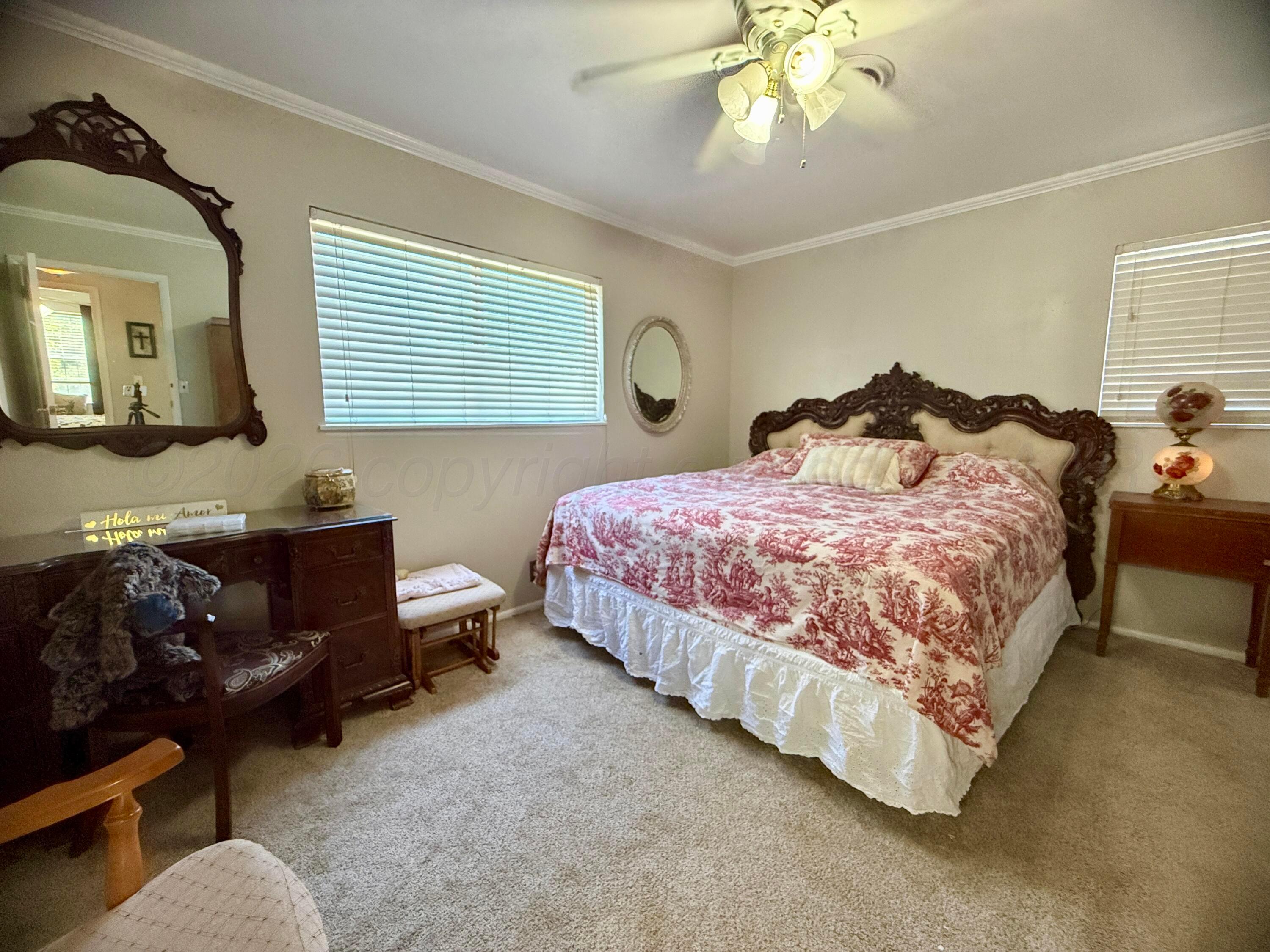 219 Inverness Street Borger, TX 79007 - Photo 21 of 35 a bedroom with a bed couch and window