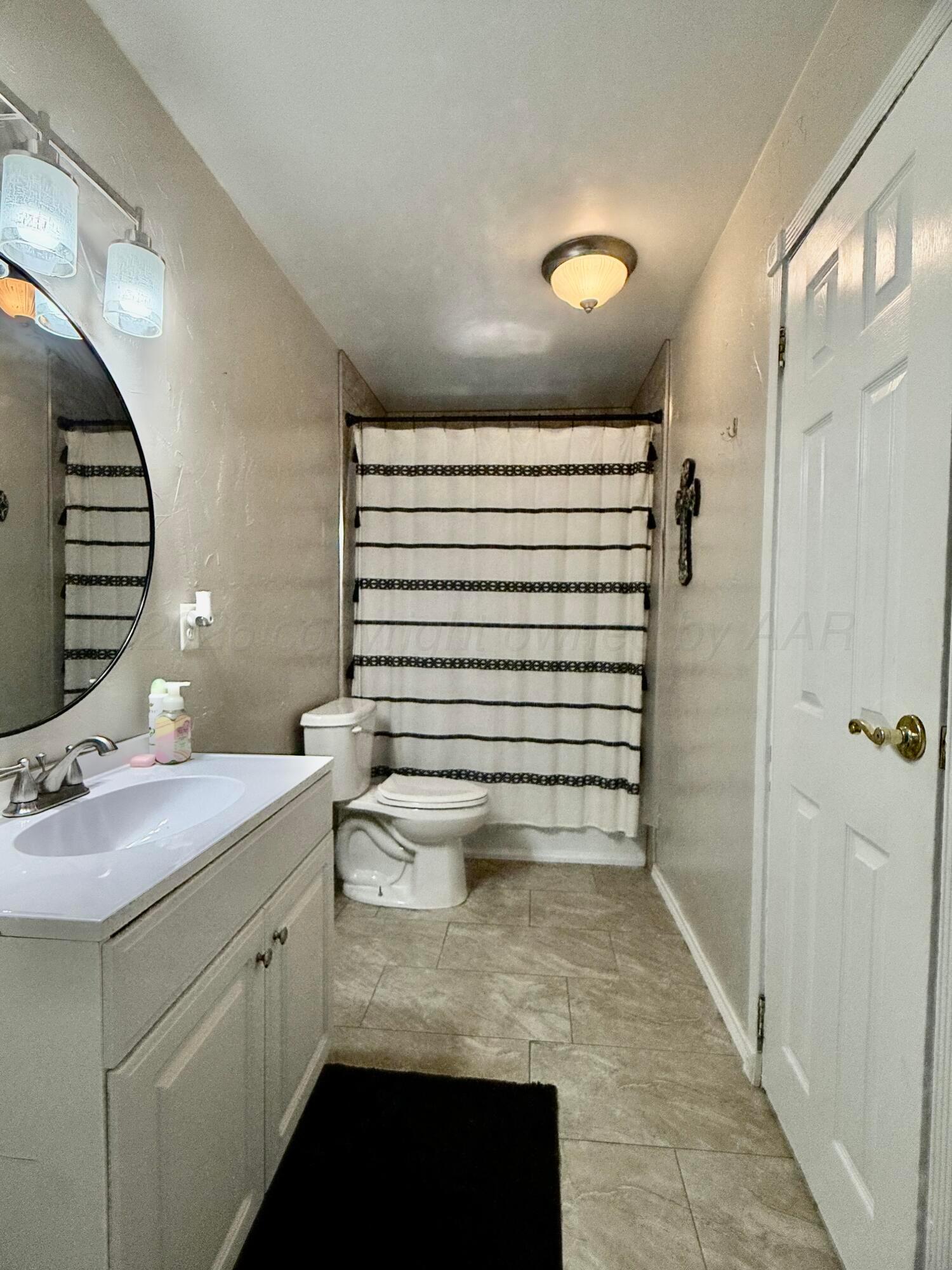 219 Inverness Street Borger, TX 79007 - Photo 24 of 35 a bathroom with a sink and a mirror