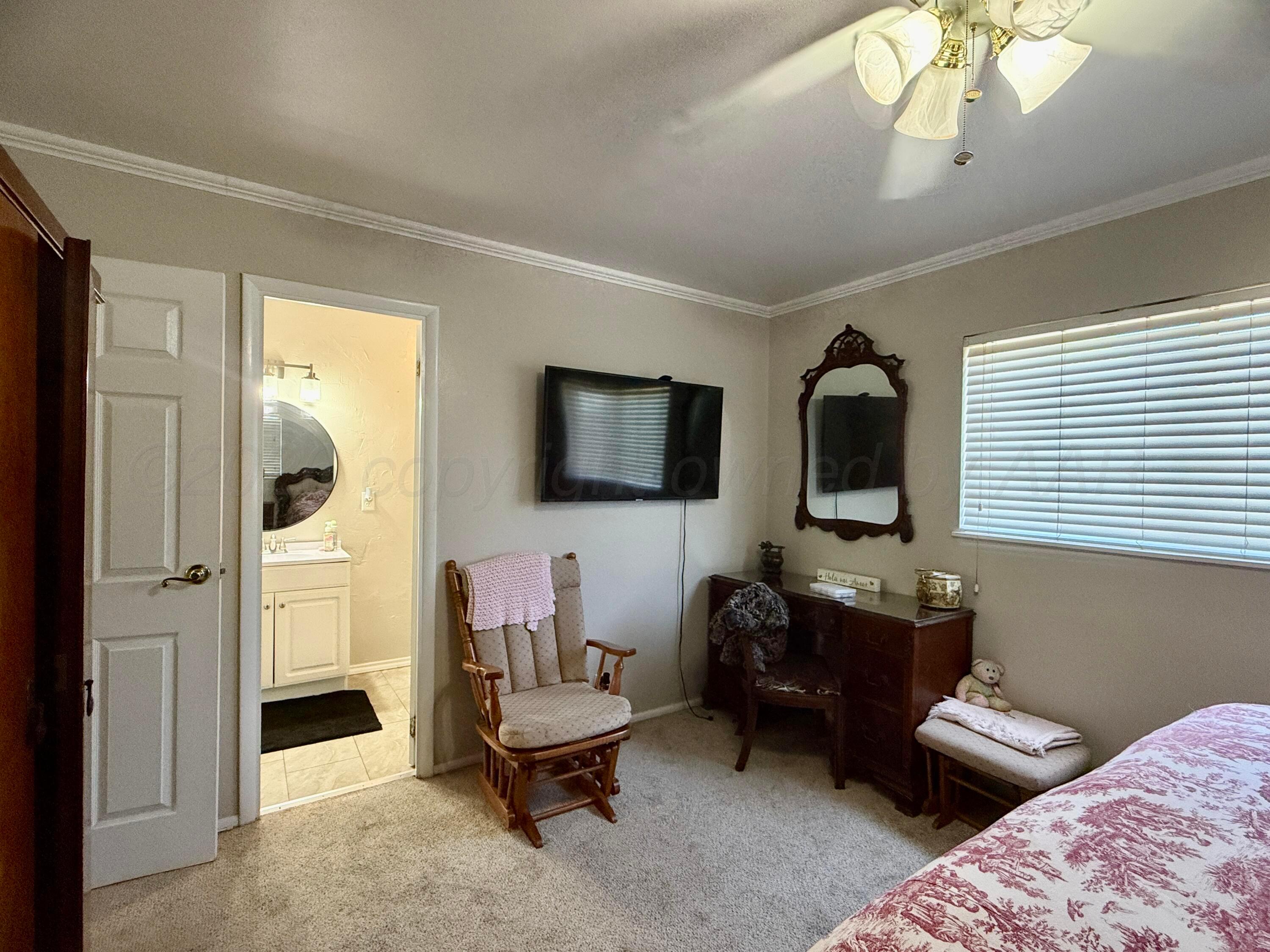 219 Inverness Street Borger, TX 79007 - Photo 26 of 35 a living room with furniture a flat screen tv and a window