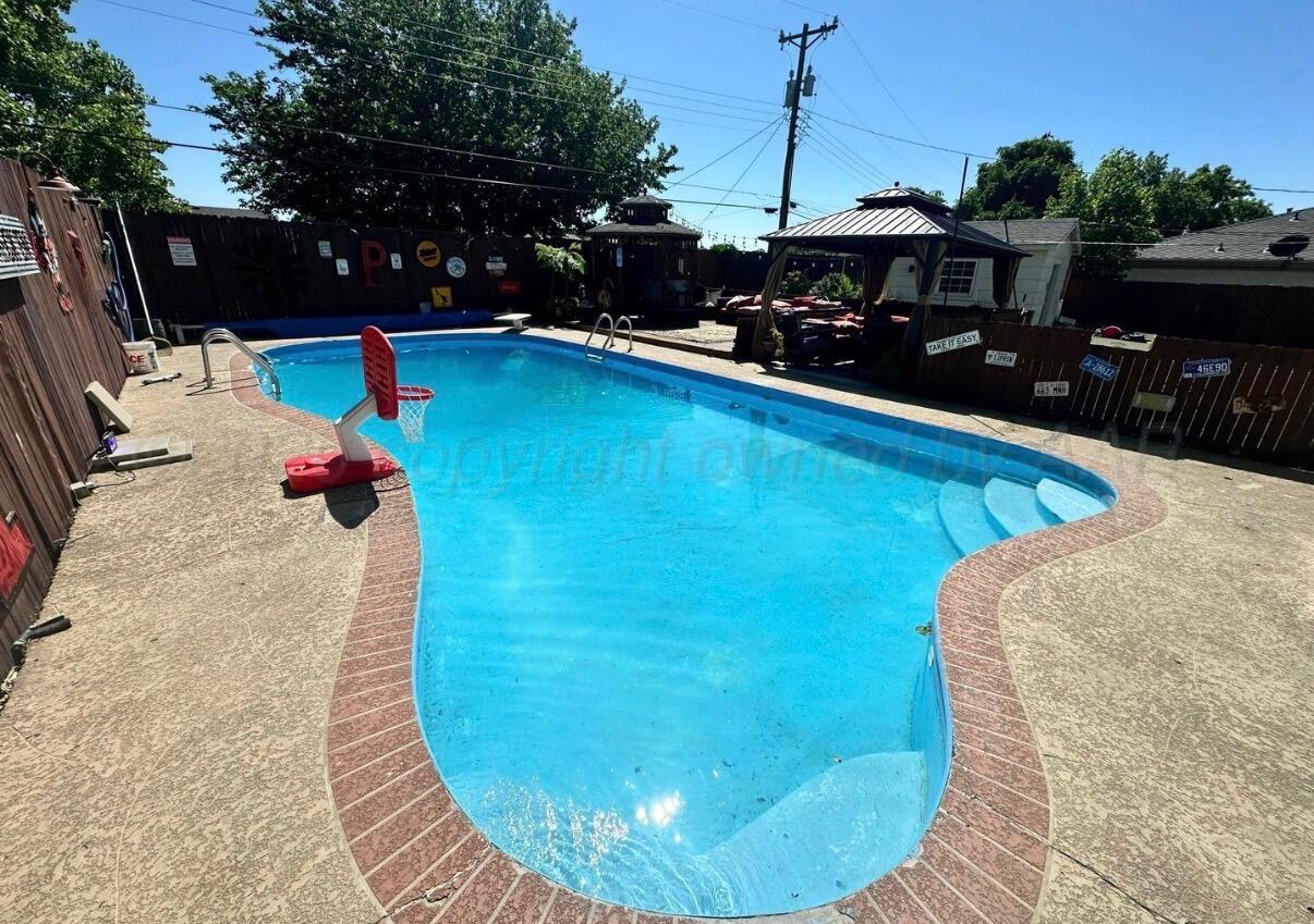 219 Inverness Street Borger, TX 79007 - Photo 29 of 35 a view of a swimming pool with sitting area