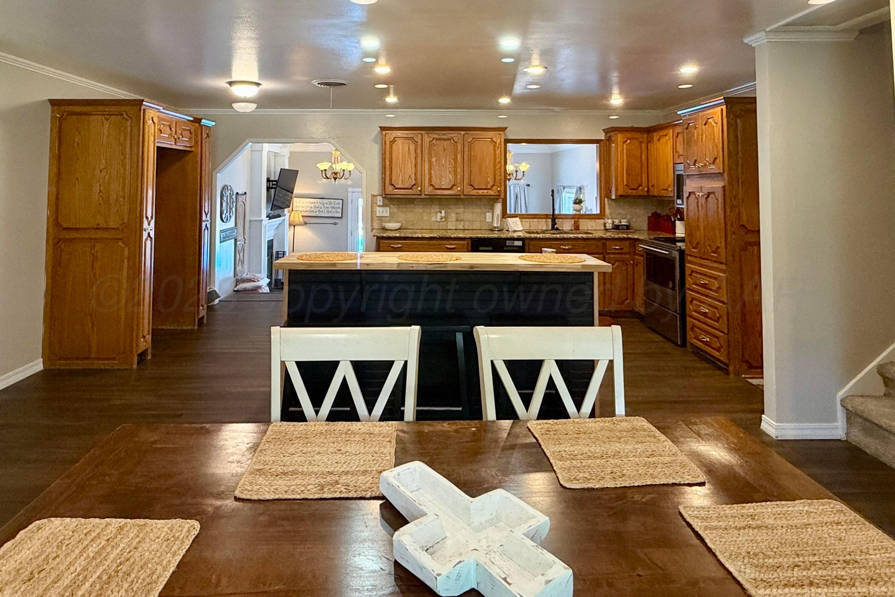 219 Inverness Street Borger, TX 79007 - Photo 10 of 35 a kitchen with a stove a refrigerator and a microwave