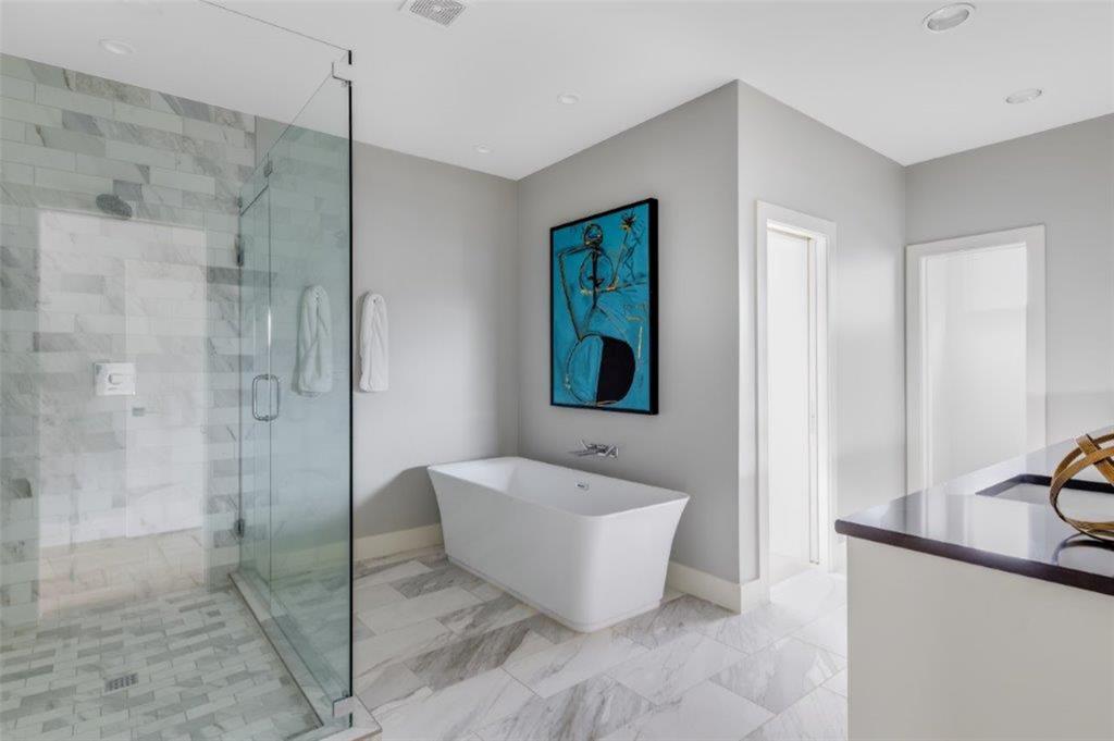 3706 West Beverly Drive Dallas, TX 75209 - Photo 11 of 12 a bathroom with a bathtub and shower