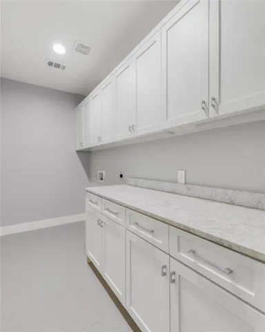 a kitchen with white cabinets and a sink