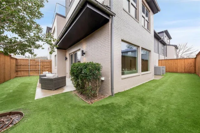 a view of an house with backyard space and garden