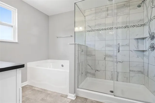 a bathroom with a bathtub and a shower