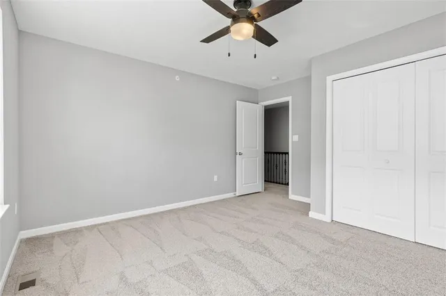 an empty room with chandelier fan