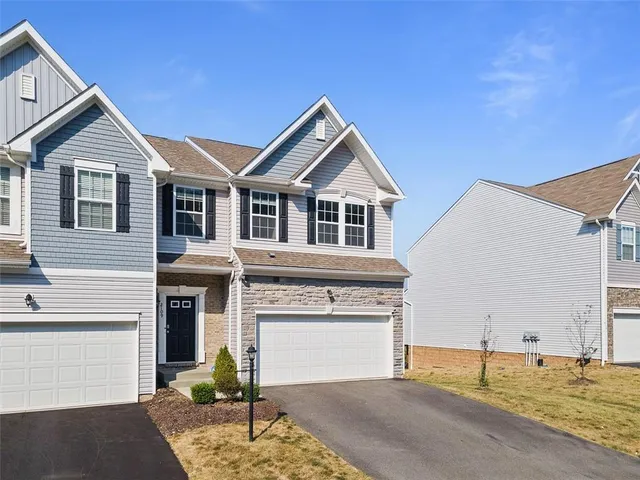 a view of a house with a garage and window