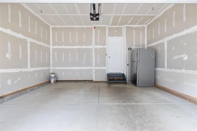 an empty room with white walls and windows
