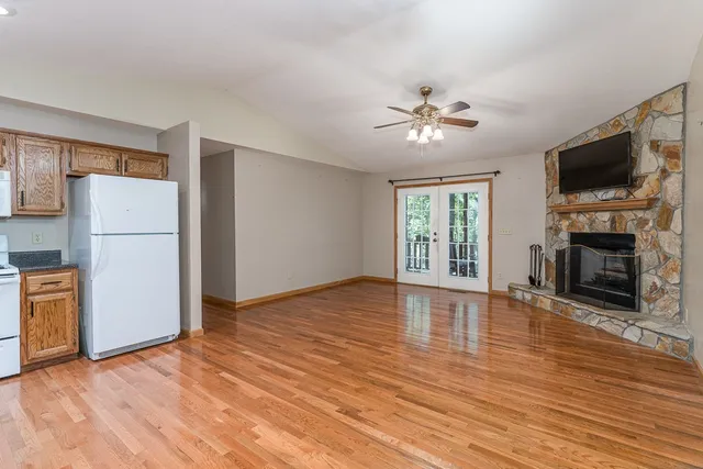 a view of livingroom with hardwood floor fireplace and a window