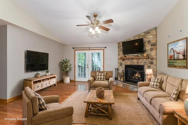 a living room with furniture a flat screen tv and a fireplace