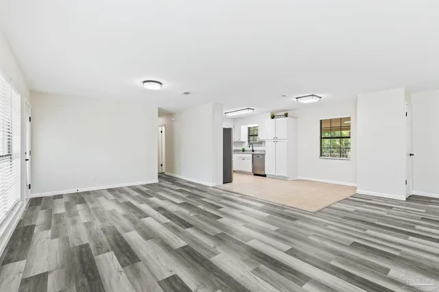 a kitchen with white cabinets and white appliances