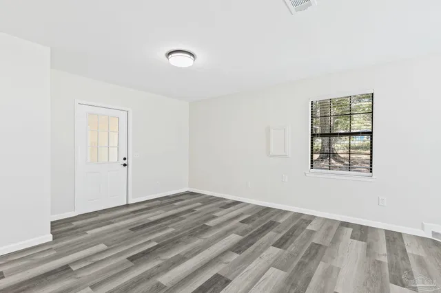 a kitchen with granite countertop white cabinets and a window