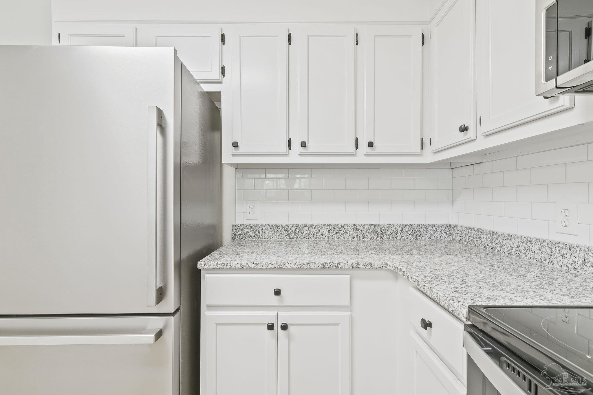 4200 Rigby Road Century, FL 32535 - Photo 20 of 71 a kitchen with granite countertop white cabinets and refrigerator