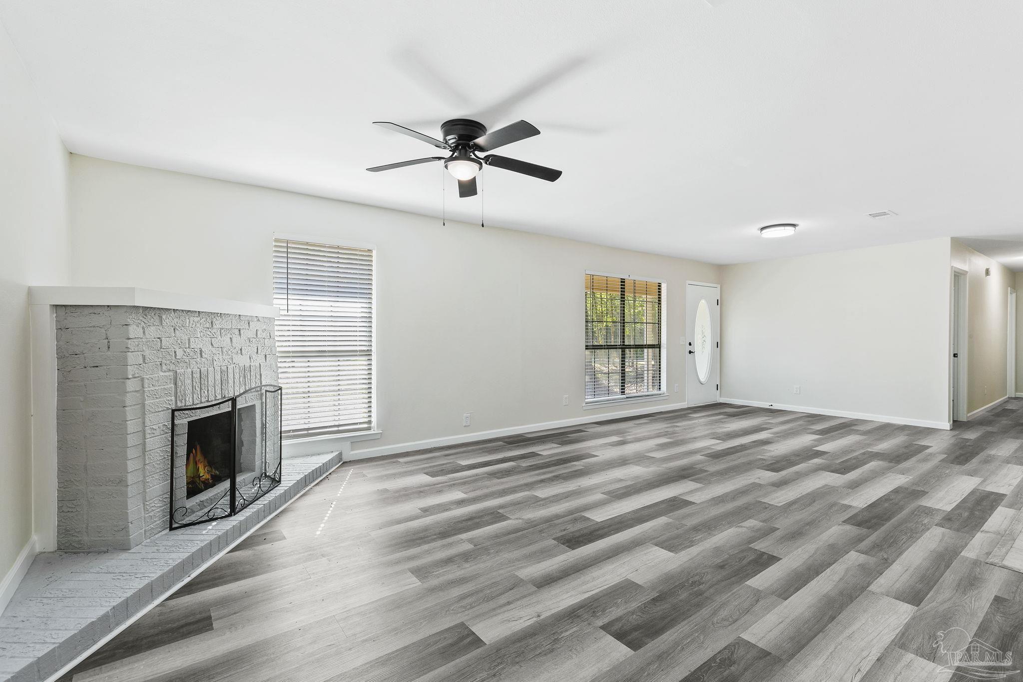 4200 Rigby Road Century, FL 32535 - Photo 3 of 71 a view of empty room with fireplace and wooden floor