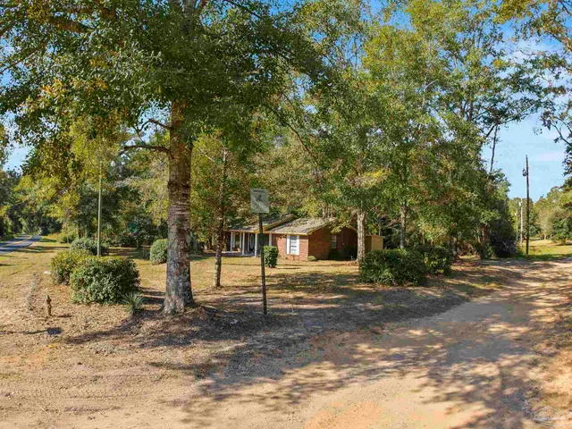 a view of a balcony with wooden floor and fence