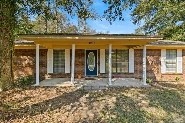 a view of a porch with a floor to ceiling window next to a yard