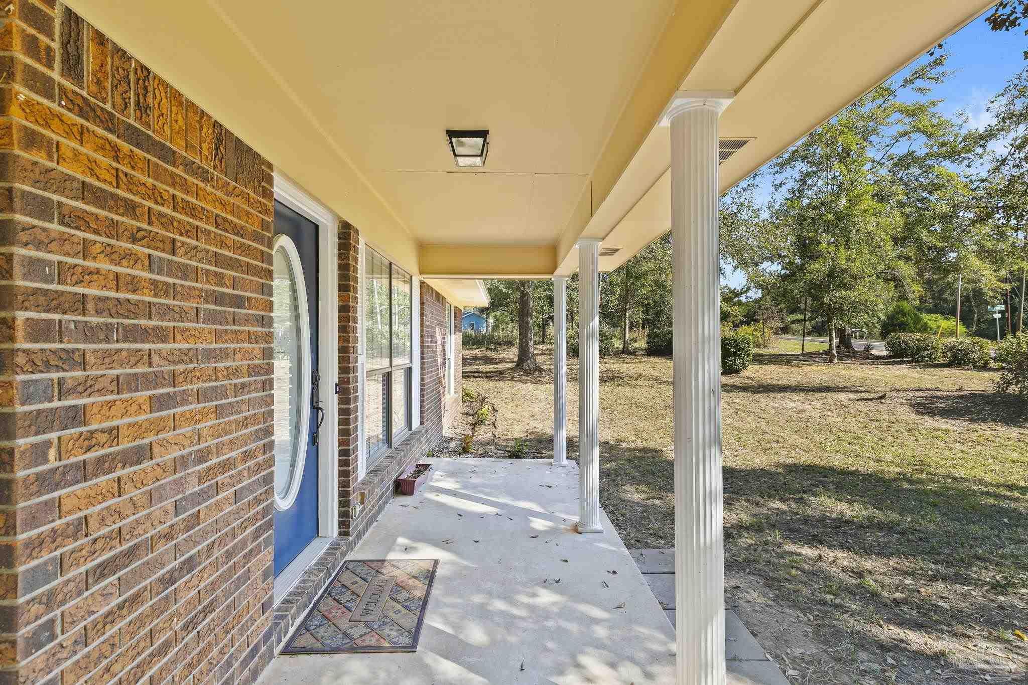 4200 Rigby Road Century, FL 32535 - Photo 9 of 71 a view of a porch with a floor to ceiling window next to a yard