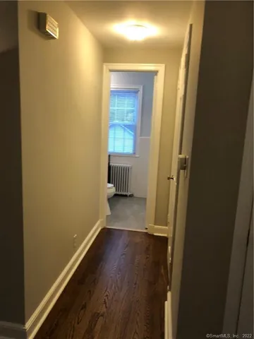 a view of a room with wooden floor