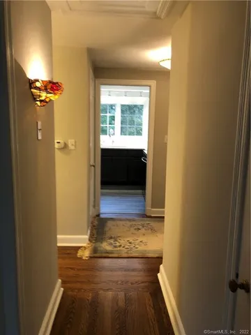 a view of a room with wooden floor and a window