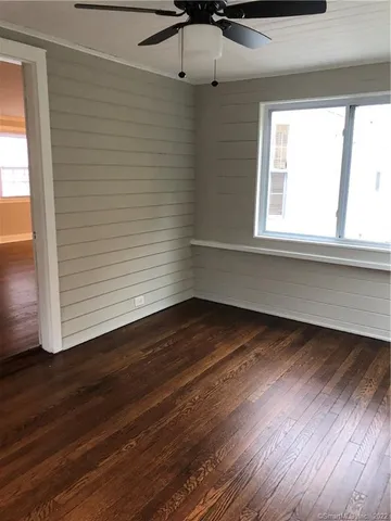 a view of room with window and wooden floor