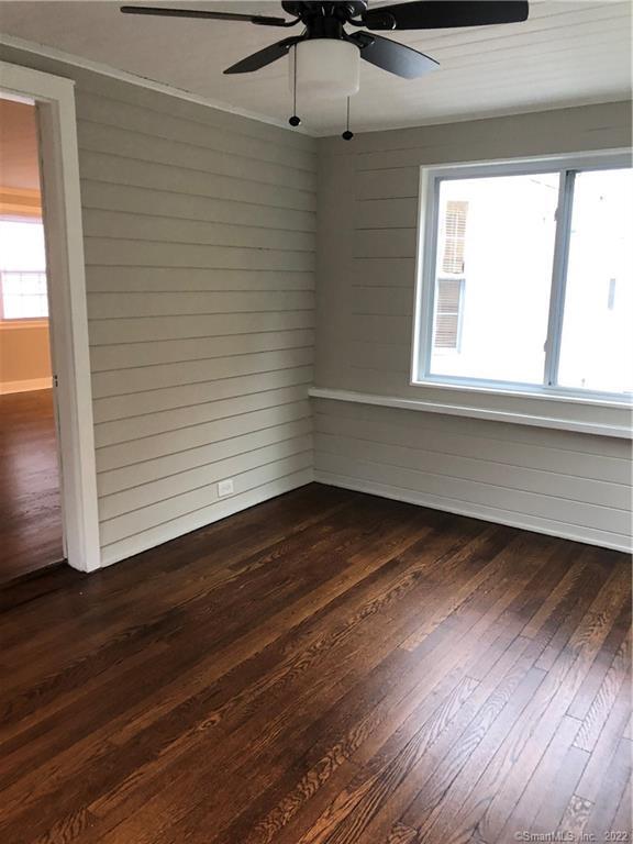 66 Hillandale Road, Unit 2 Fairfield, CT 06825 - Photo 19 of 33 a view of an empty room with wooden floor and a window