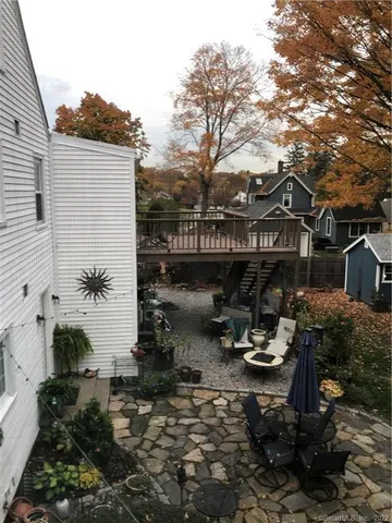 a view of a patio with chair and tables back yard of the house