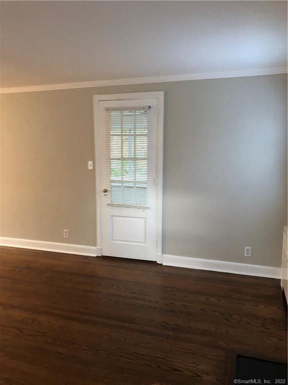 66 Hillandale Road, Unit 2 Fairfield, CT 06825 - Photo 24 of 33 a view of an empty room with wooden floor and a window