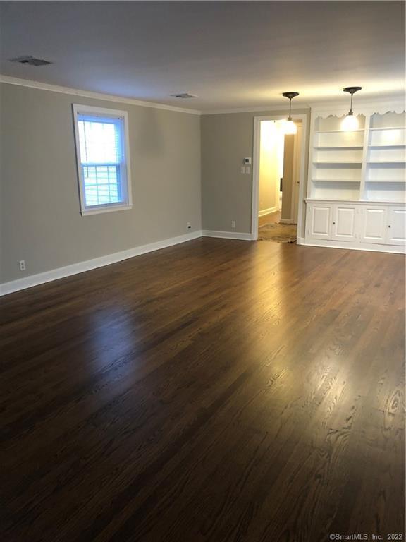 66 Hillandale Road, Unit 2 Fairfield, CT 06825 - Photo 25 of 33 an empty room with wooden floor and window