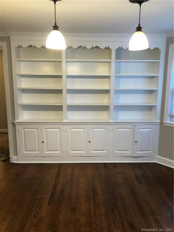 66 Hillandale Road, Unit 2 Fairfield, CT 06825 - Photo 27 of 33 a view of an empty room with a window and wooden floor