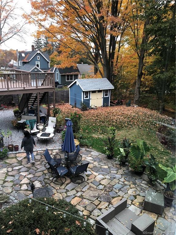 66 Hillandale Road, Unit 2 Fairfield, CT 06825 - Photo 28 of 33 a view of a house with backyard water fountain and a tree