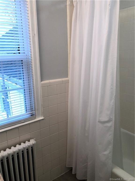 66 Hillandale Road, Unit 2 Fairfield, CT 06825 - Photo 4 of 33 a bathroom with a shower curtain