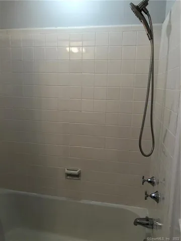 a bathroom with a shower and a shower