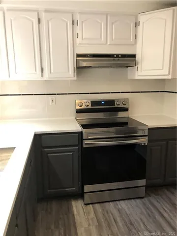 a stove top oven sitting inside of a kitchen